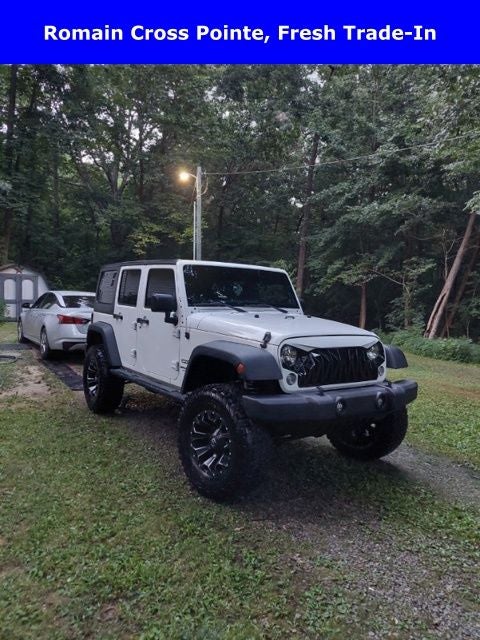 2014 Jeep Wrangler Unlimited Sport in Bright White Clearcoat — front three-quarter view